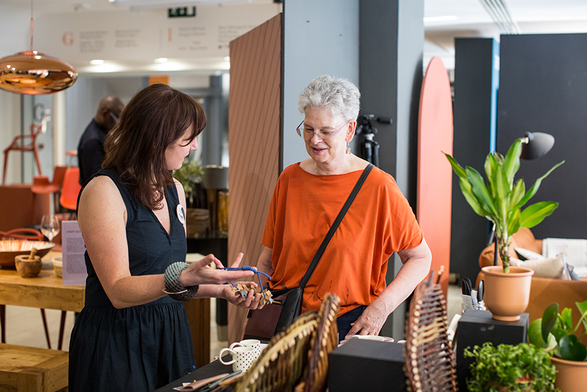 Jo Scott with a customer at London Craft Week 2018 / Photography by Sophie Mutevelian