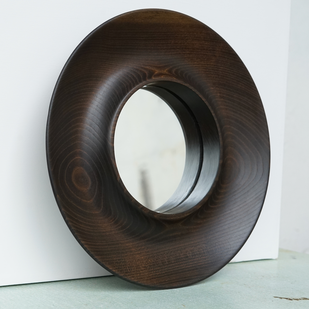 Ebonised cherry framed mirror.